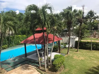 a resort with a swimming pool and palm trees at La Gaviota A3 in Juan Dolio