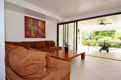 a living room with a couch and a table at Las Terrenas Front Beach And Garden Villa with private staff in Las Terrenas