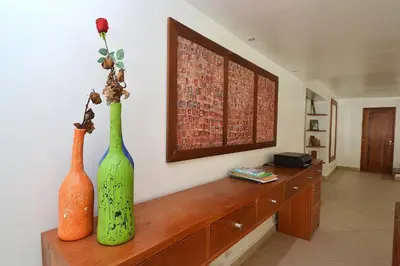 two vases sitting on a wooden shelf in a room at Las Terrenas Front Beach And Garden Villa with private staff in Las Terrenas