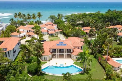 an aerial view of a house with a swimming pool and the ocean at Exclusive Villa at Hideaway Beach in Cabarete