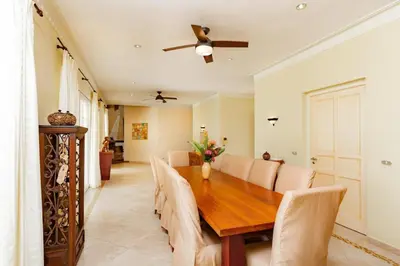 a dining room with a wooden table and chairs at Exclusive Villa at Hideaway Beach in Cabarete