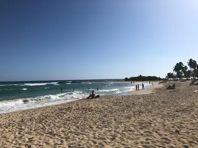 a group of people on a beach near the ocean at La Gaviota B3 in Juan Dolio