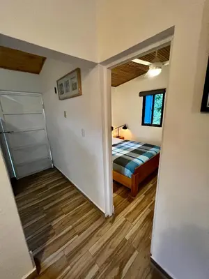 a room with a bed and a room with a closet at Haus unter Palmen in Jarabacoa