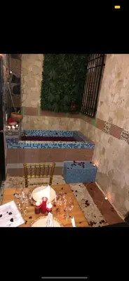 a table with wine glasses on top of it at Mansion Colonial Boutique Hotel Pool Jacuzzi Bar Restaurant by BTC Group Crypto in Santo Domingo