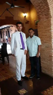 two men standing next to each other in a room at Mansion Colonial Boutique Hotel Pool Jacuzzi Bar Restaurant by BTC Group Crypto in Santo Domingo