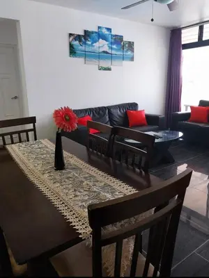 a living room with a table and a couch at The biggest swimming pool in Sosua, frente a la piscina más grande en sosua in Sosúa