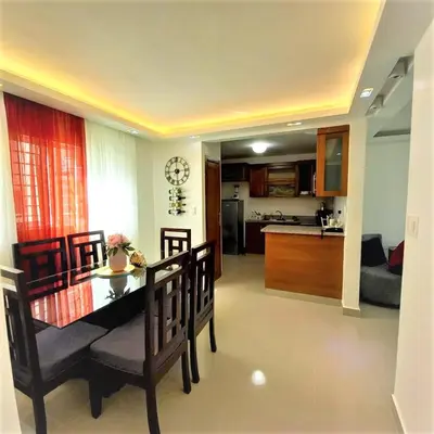 a kitchen and living room with a table and chairs at Your Space piscina, parque infantil, 3 habitaciones , Res Breezes Santiago in Santiago de los Caballeros