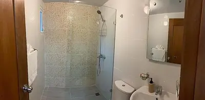 a bathroom with a shower and a toilet at Your Space piscina, parque infantil, 3 habitaciones , Res Breezes Santiago in Santiago de los Caballeros