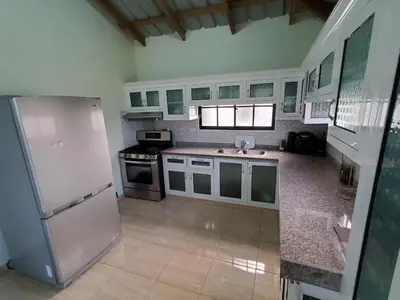 a kitchen with a white refrigerator and a sink at Oasis de Paz 3 in Jarabacoa