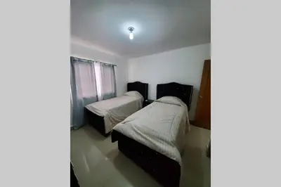 a bedroom with two beds and a window at Hanly Roger's Brand new place in San Felipe de Puerto Plata
