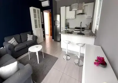 a kitchen and living room with a couch and a table at Apartamento Estrella Dominicus in La Laguna