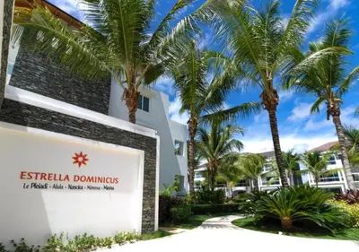 a sign in front of a building with palm trees at Apartamento Estrella Dominicus in La Laguna