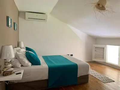 a bedroom with a large bed with a blue blanket at Ballenas beach C6 in Las Terrenas