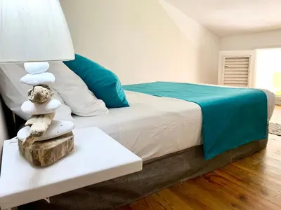 a bedroom with a bed and a table with towels at Ballenas beach C6 in Las Terrenas