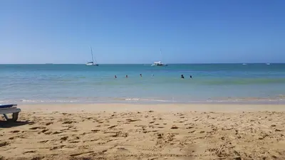 a group of people in the water at the beach at Saman Terrace in Las Terrenas