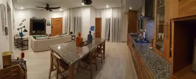 a large living room with a table and a couch at Saman Terrace in Las Terrenas