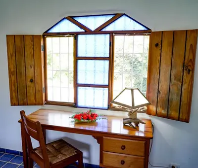 a room with a desk with a lamp and windows at Villa directly on the beach, las Ballenas in Las Terrenas