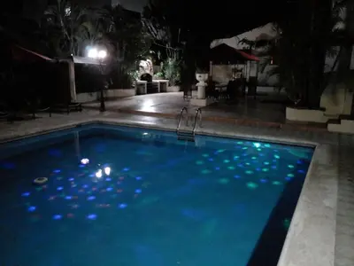 a swimming pool at night with lights on it at Villa Los Almendros - 2 private pools tennis pickle ball in Baní