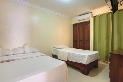 two beds in a room with green curtains at Quiet 1 Bedroom Apartment Premium Wi-Fi 2 beds 15 minutes from the airport in La Viva
