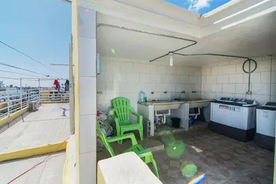 a kitchen with green chairs and a table on a roof at Quiet 1 Bedroom Apartment Premium Wi-Fi 2 beds 15 minutes from the airport in La Viva