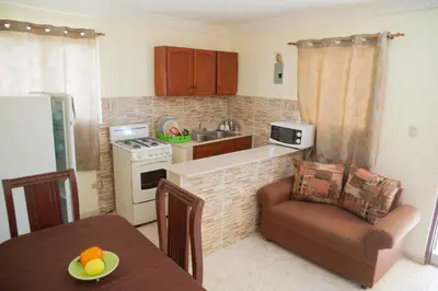 a kitchen with a table and a chair in a kitchen at Quiet 1 Bedroom Apartment Premium Wi-Fi 2 beds 15 minutes from the airport in La Viva