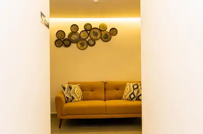 a living room with a couch and plates on the wall at HOTEL ALKQUIMIA in Bayahibe