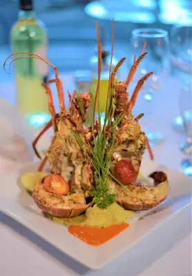 a plate of food with shrimp on a table at HOTEL ALKQUIMIA in Bayahibe
