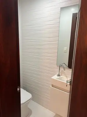 a bathroom with a toilet and a sink and a mirror at Amazing Rooftop and Best View of the City in Santiago de los Caballeros
