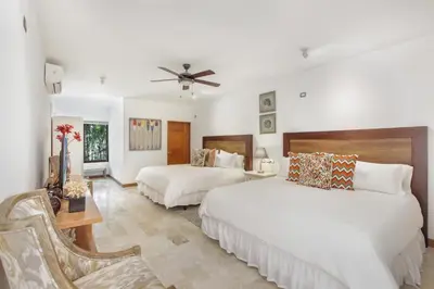 a bedroom with two beds and a ceiling fan at Stunning Villa with Private Pool and Jacuzzi in Casa de Campo in La Romana