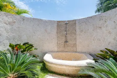 a bath tub sitting next to a concrete wall at Stunning Villa with Private Pool and Jacuzzi in Casa de Campo in La Romana