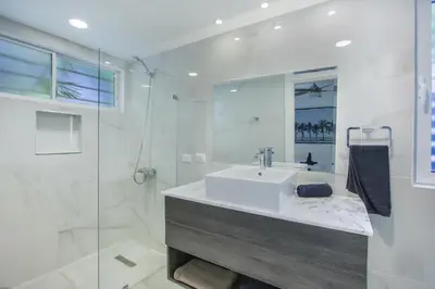 a white bathroom with a sink and a shower at Luxury Villa in Bávaro Just on the Beach in Punta Cana