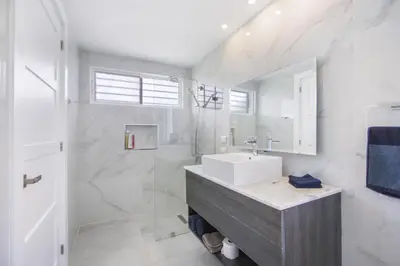 a white bathroom with a sink and a shower at Luxury Villa in Bávaro Just on the Beach in Punta Cana