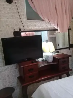 a television on a table in a bedroom at Villa Julirous Rd, spa and aparthotel camp for vacationers in Boca Chica