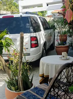 a white van parked next to a table with a cup of coffee at Villa Julirous Rd, spa and aparthotel camp for vacationers in Boca Chica