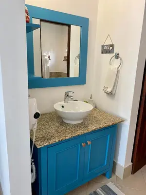 a bathroom with a blue sink and a mirror at Palmeraie Terrenas beach apartamento in Las Terrenas