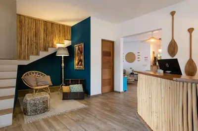 a living room with blue walls and a staircase at TAKUMA BOUTIK HOTEL in Las Terrenas