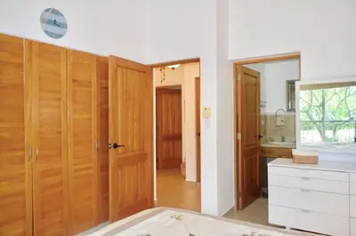 a kitchen with wooden cabinets and a white counter top at 3BR Apt @CadaquesCaribe Bayahibe in San Rafael del Yuma