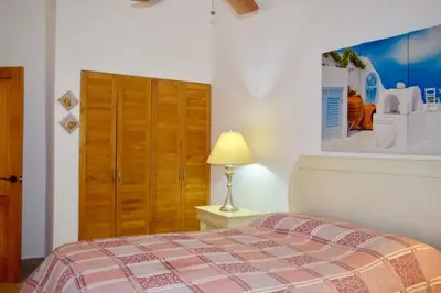 a bedroom with a bed and a lamp on a table at 3BR Apt @CadaquesCaribe Bayahibe in San Rafael del Yuma