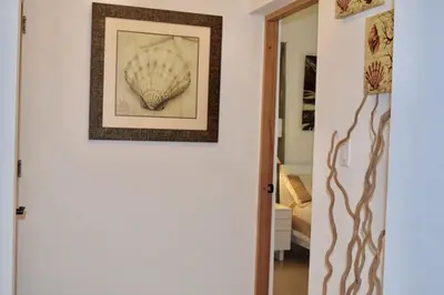 a picture of a shell hanging on a wall at 3BR Apt @CadaquesCaribe Bayahibe in San Rafael del Yuma