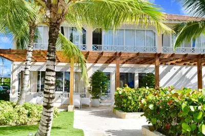 a palm tree in front of a building at 3BR Apt @CadaquesCaribe Bayahibe in San Rafael del Yuma