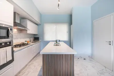 a kitchen with white cabinets and a counter top at Playa Bonita Amazing Condo at Lake View in La Ceiba