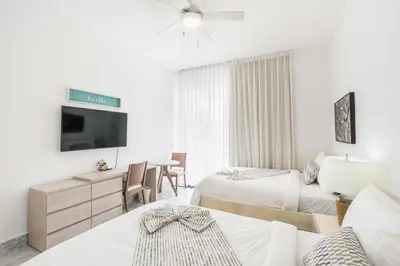 a hotel room with two beds and a tv at Playa Bonita Amazing Condo at Lake View in La Ceiba
