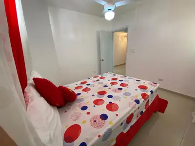 a bedroom with a bed with polka dots on it at Santiago City Center Huge nice Apartment to stay rooftop to enjoy the city view in Santiago de los Caballeros