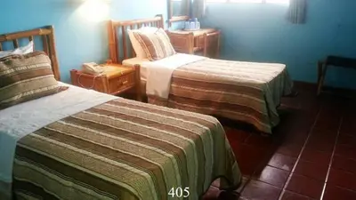 a hotel room with two beds in a room at Hotel Caribe in Santa Cruz de Barahona