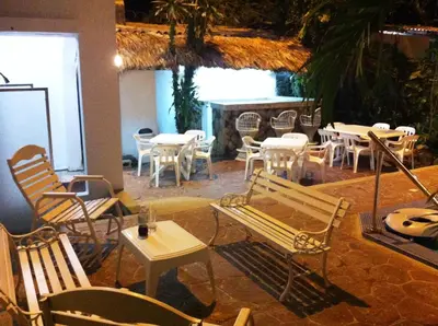 a room with tables and chairs and tables and chairs at Hotel Caribe in Santa Cruz de Barahona