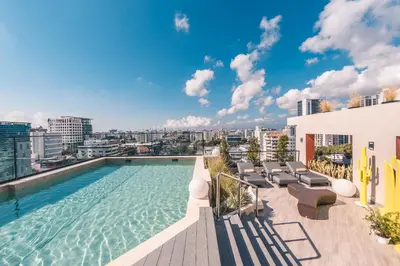 a swimming pool on the roof of a building at Fully Serviced Apartment at Regatta Living - 3B in Santo Domingo
