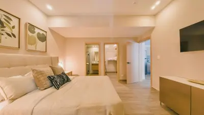 a bedroom with a large bed and a television at Fully Serviced Apartment at Regatta Living II - 703 in La Julia