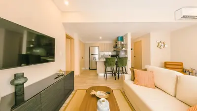 a living room with a white couch and a table at Fully Serviced Apartment at Regatta Living II - 703 in La Julia