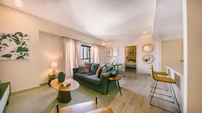 a living room with a couch and a table at Fully Serviced Apartment at Regatta Living - 9F in Santo Domingo