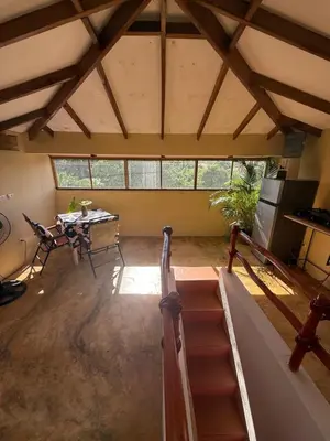 a large room with a table and a dining room at Yes Papa! Rooms only 100m from the beach! in Las Galeras